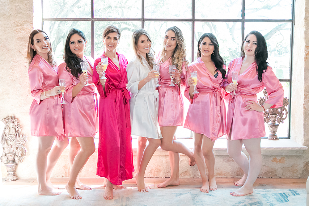 bridesmaids pink robes in bridal suite