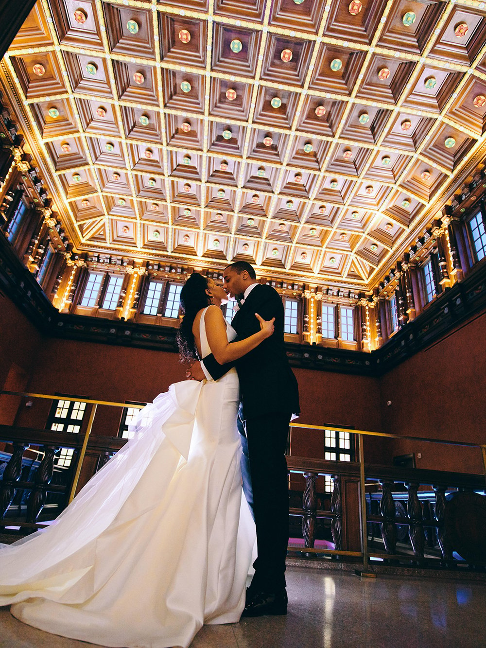 couple dancing under the artistic, breathtaking ceiling at the houston library