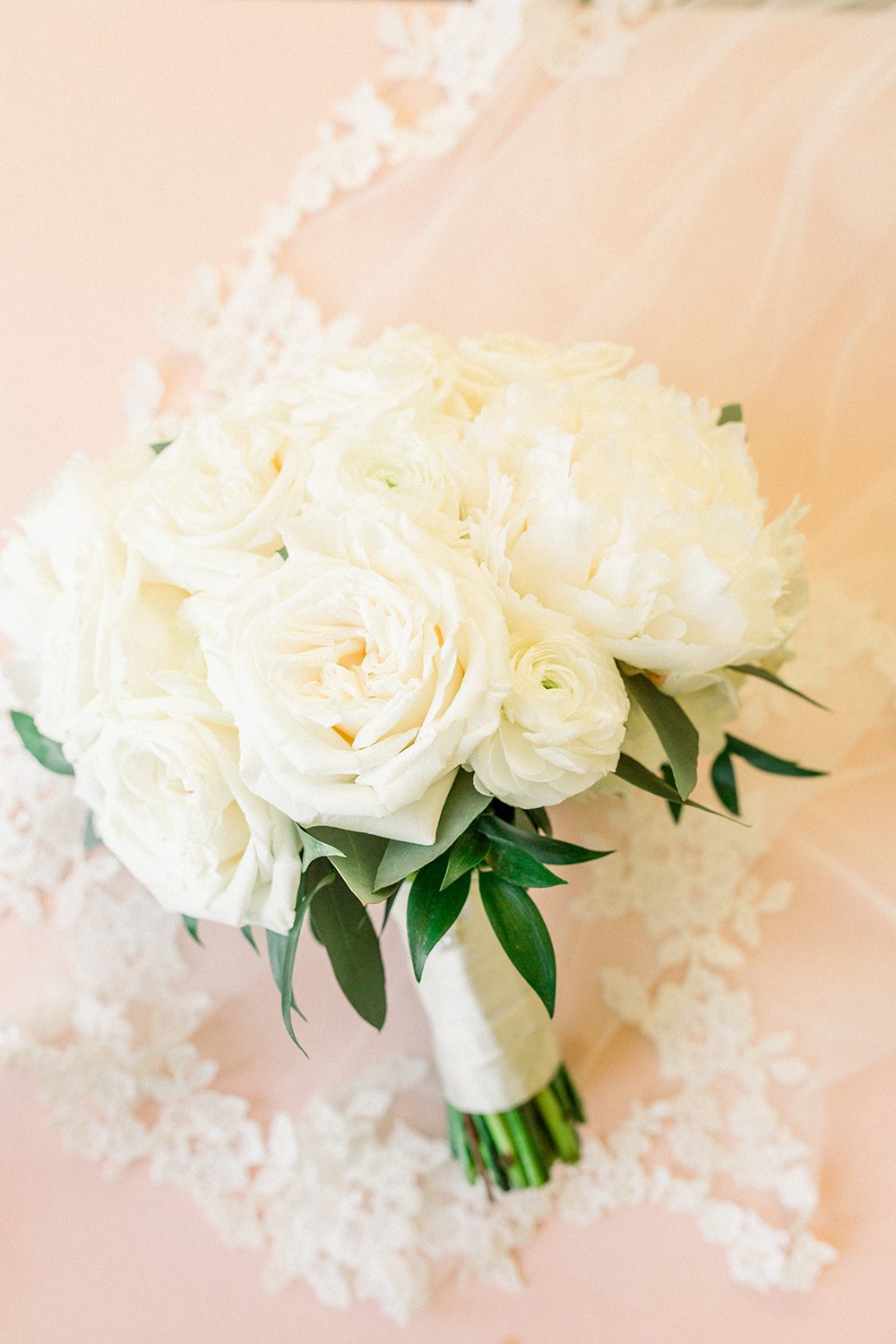 white bouquet with blush background
