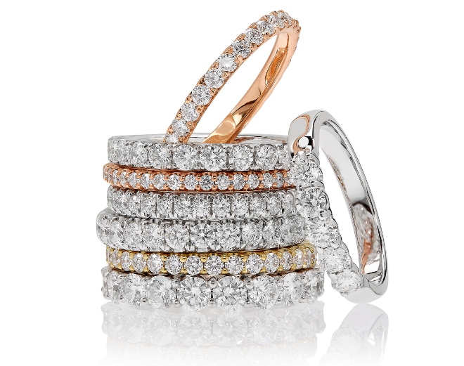 8 diamond wedding bands stacked on top of each other. 