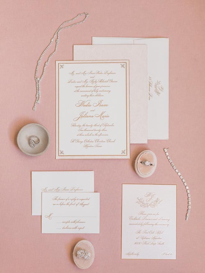 The couple has white and gold wedding stationery and invitations from Bering's.
