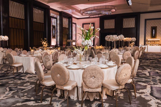 Floral centerpieces decorate the tablescapes of the venue's ballroom.