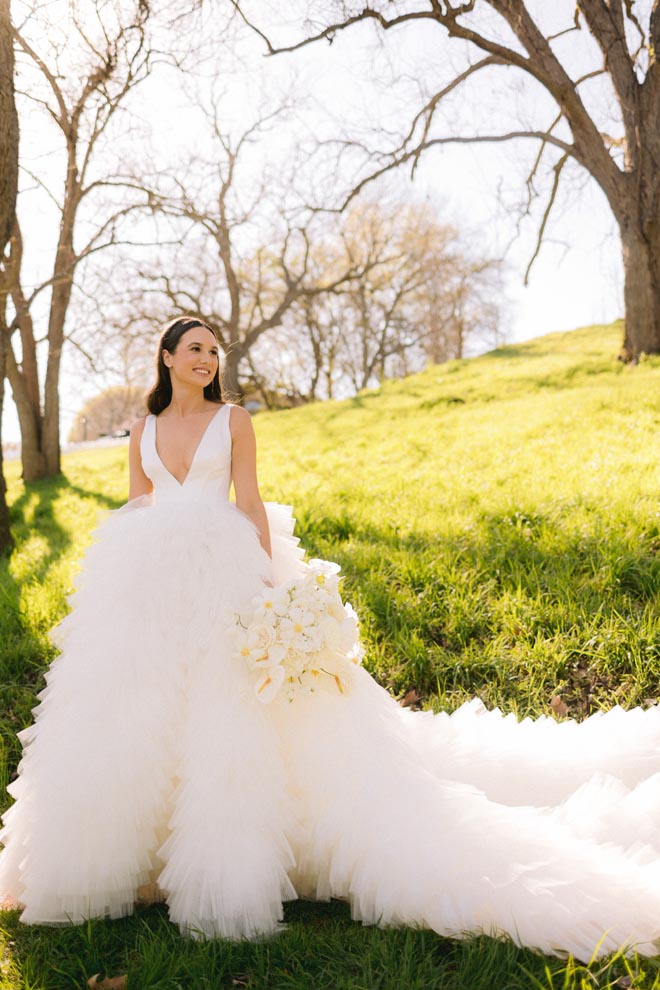The bride wears a Rita Vinieris designer gown for her sun-kissed al fresco wedding day.