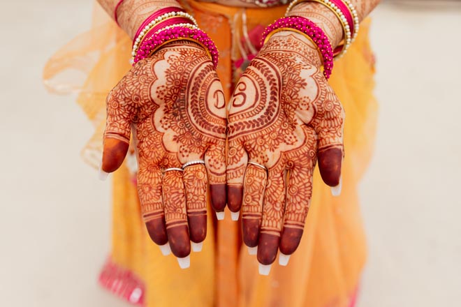 The bride's palms are detailed in henna for her tropical Indian-fusion wedding in Mexico.