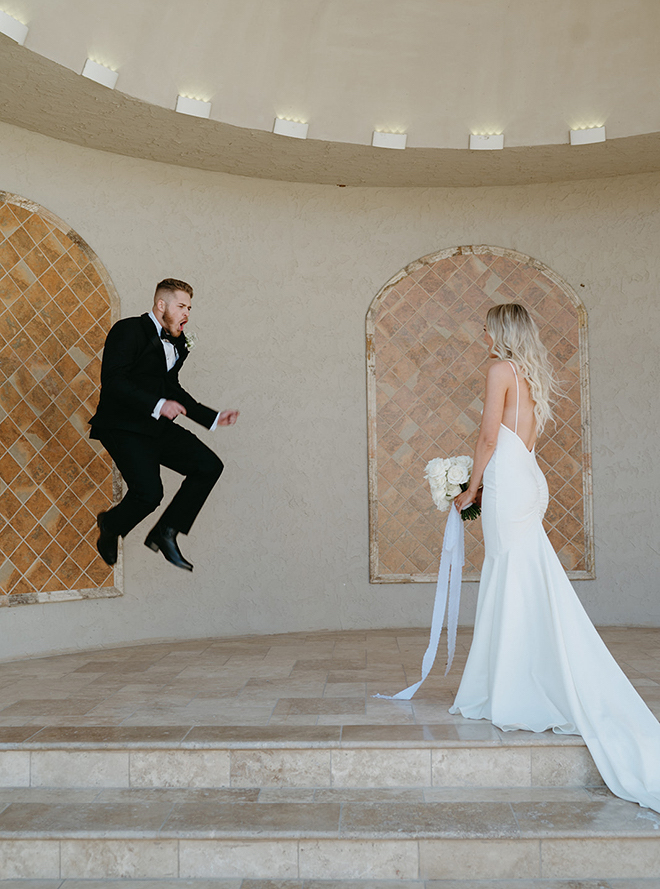 The groom jumping in the air when he turns around and sees the bride during the first look. 