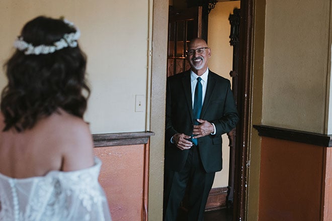 The bride and her father share a private first look before her ceremony at the Houston wedding venue, AvantGarden.