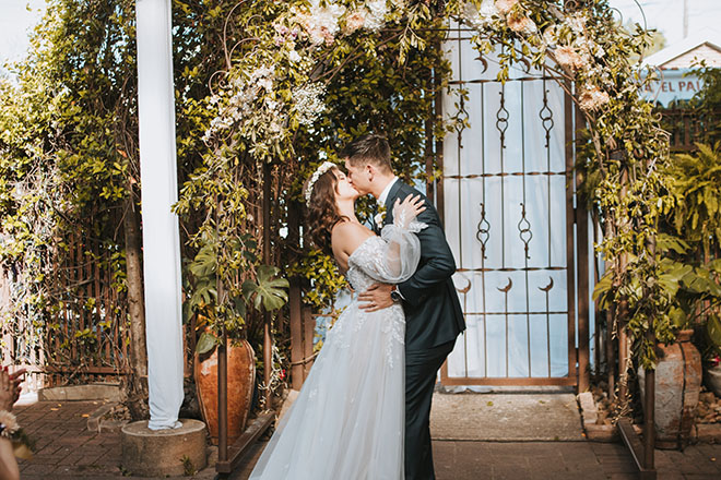 The bride and groom share a kiss at their art nouveau wedding at AvantGarden.