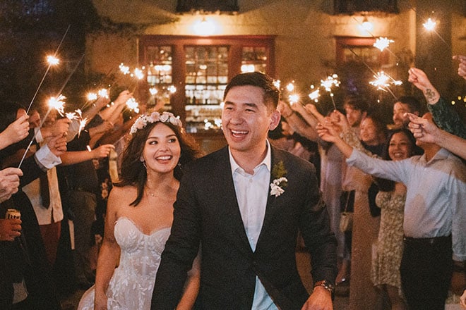 The bride and groom exit their art nouveau wedding with a sparkler send-off.