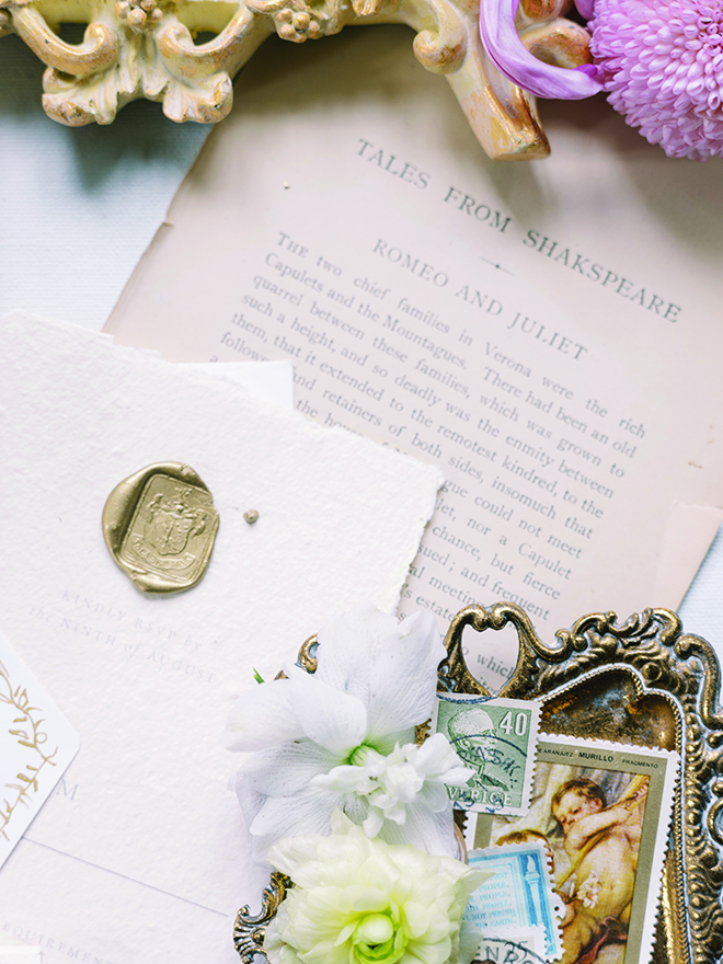 Stationery reading "Tales From Shakespeare" with a page from Romeo and Juliet, stamps and a gold wax seal on an invitation. 