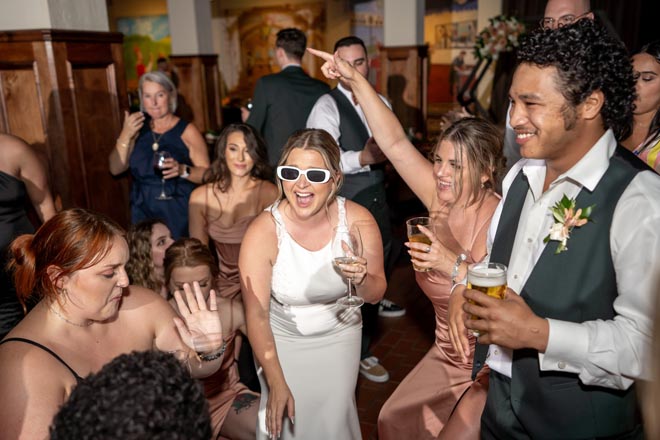 The bride and wedding guests dance at the intimate wedding celebration at Saint Arnold Brewery.