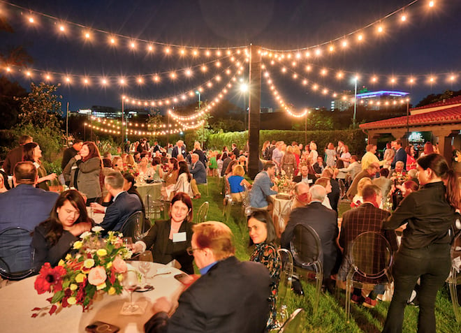 Guests enjoy Masraff's Catering at an outdoors event in Houston.
