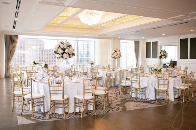 The Petroleum Club of Houston is detailed in pastel florals and greenery for a ballroom reception.