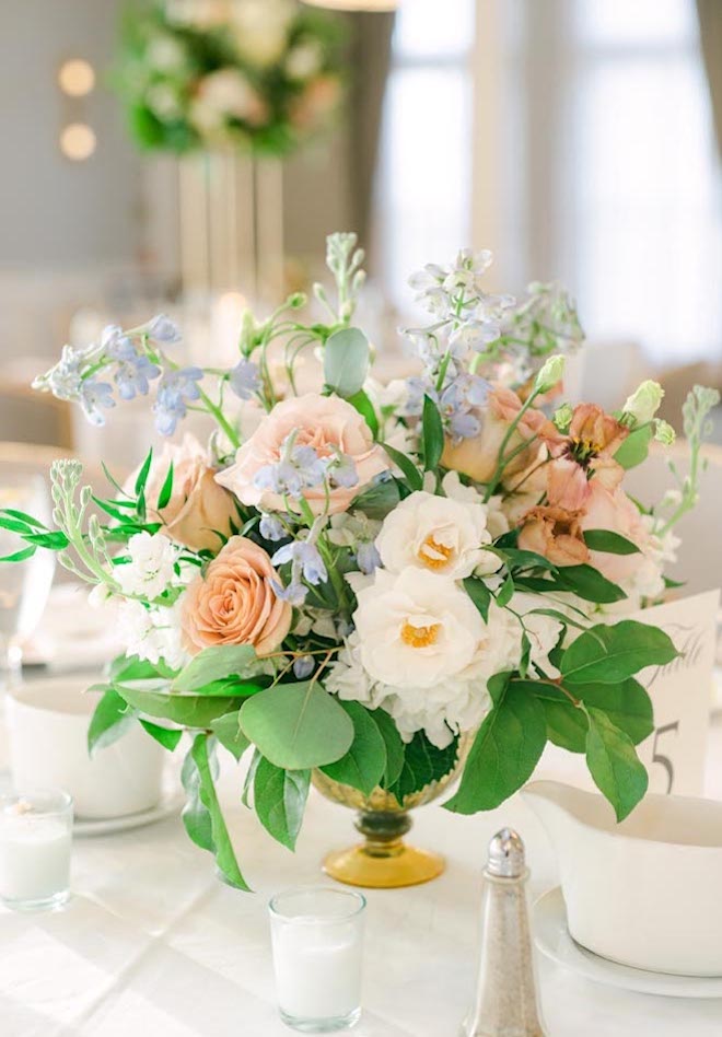 Whie, blush and light blue flowers decorate the reception tables.