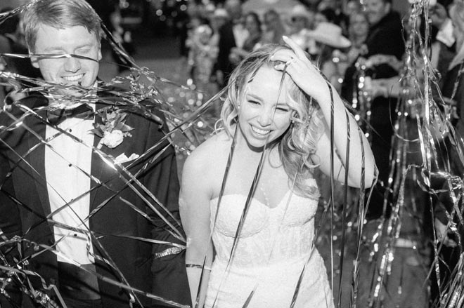 The bride and groom conclude their wedding with a streamer send-off. 