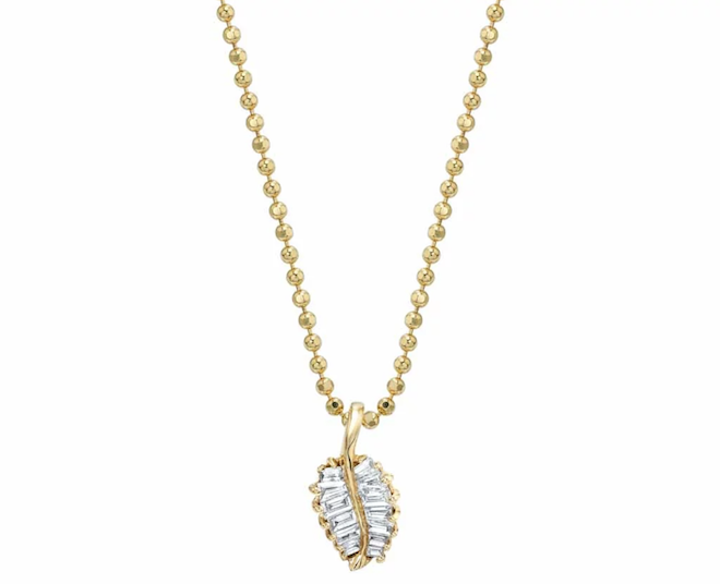 Gold necklace with a diamond palm leaf. 