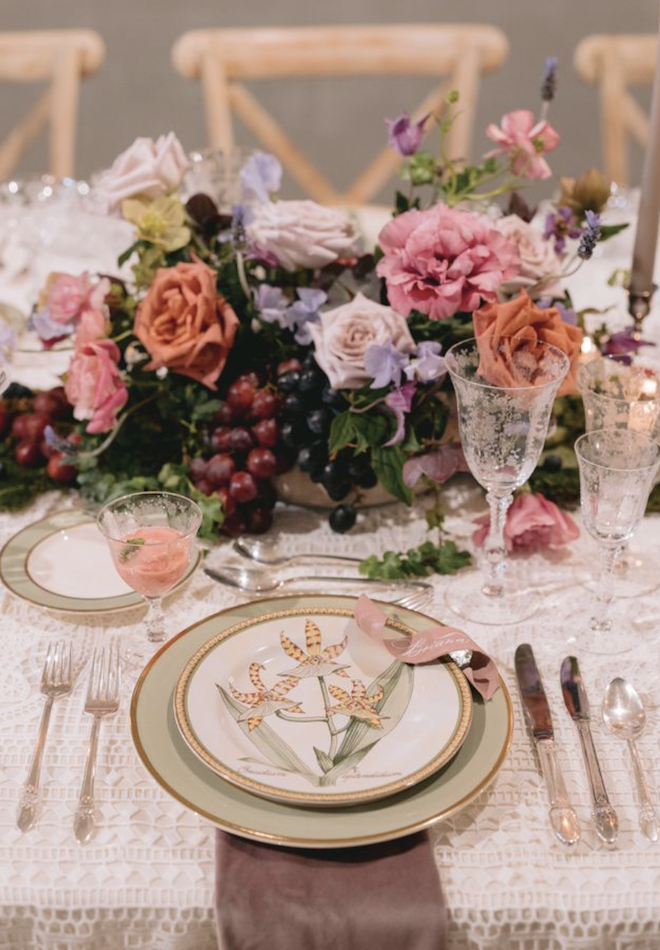 A green floral print plate with a floral centerpiece.