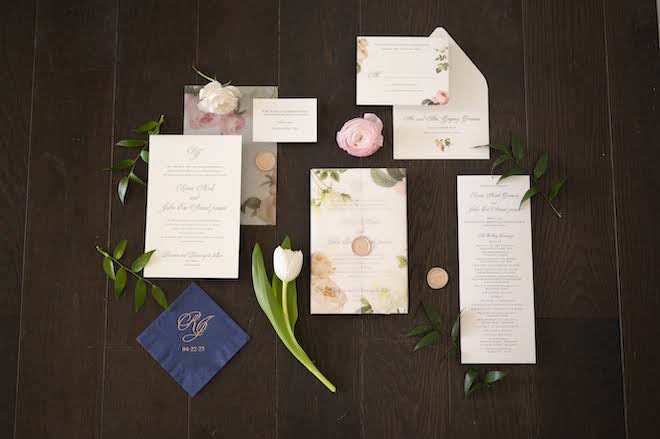 A white and floral invitation suite. 