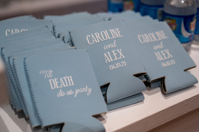Blue custom coozies that say "Till Death do us party" and a couples name with their wedidng date. 
