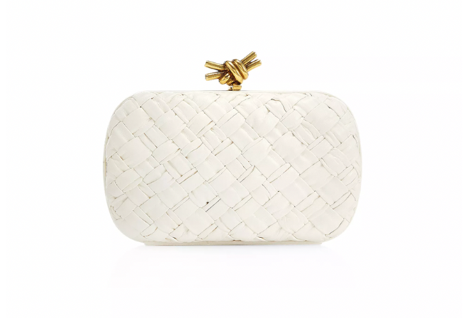 White clutch with a gold knot.