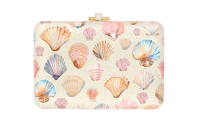 A beige square clutch with shells printed on it. 