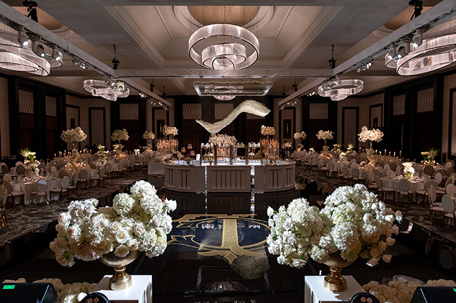 White flowers and gold accents decorate the grand ballroom reception.