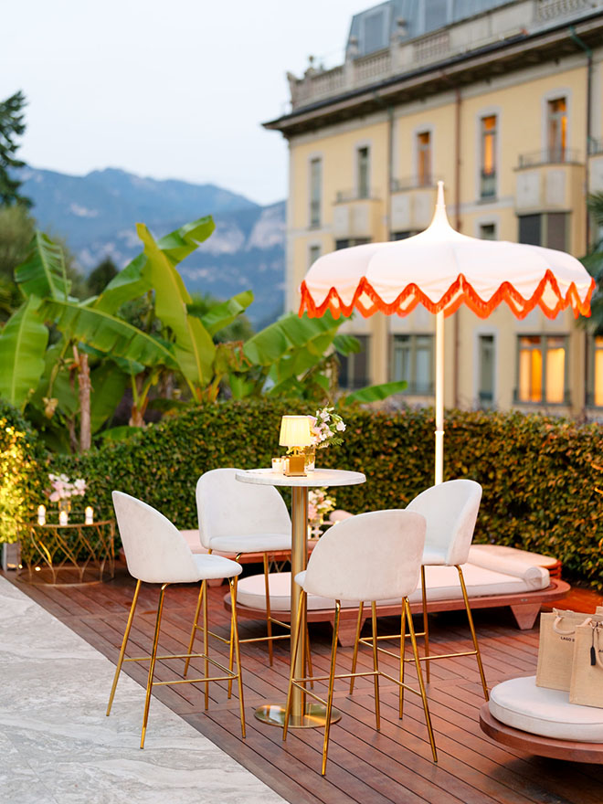 Gold and white high top tables are placed around the pool at the Grand Hotel Tremezzo.