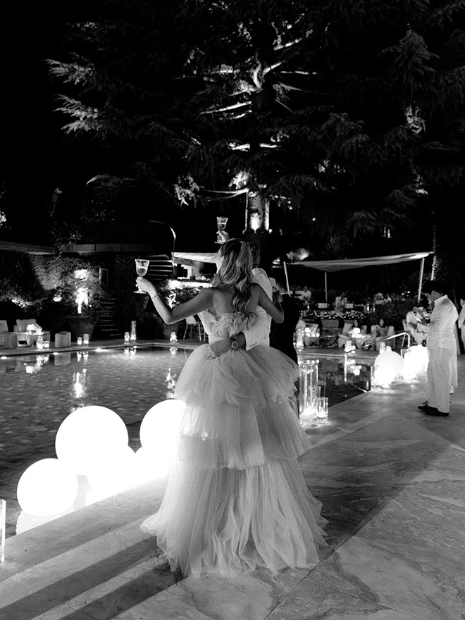 Tanya and Casper raise their glasses for a toast as friends and family give speeches.