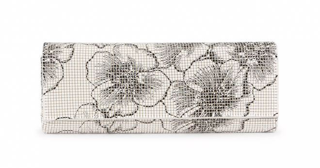 A rectangle white clutch with a black floral print. 