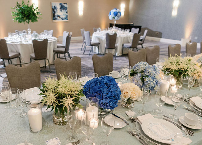 Blue hydrangeas, white roses and flowers decorate the blue-inspired wedding editorial.