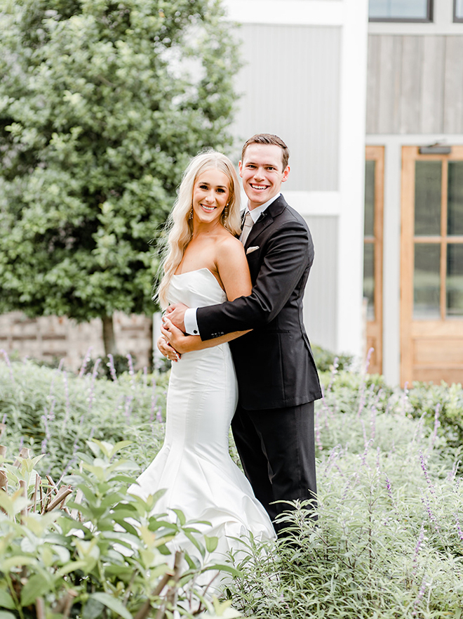 Bride and groom lock arms before getting married outside the venue. 