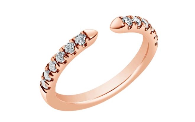 Open concept wedding ring features pointed edges at the opening of the ring and diamonds decorating the band set with split prongs.