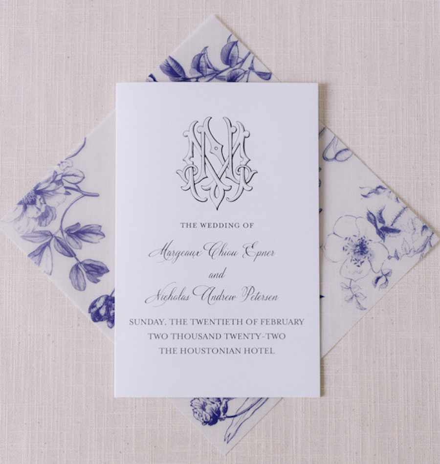 Wedding invitations with white and blue hues and floral additions. 