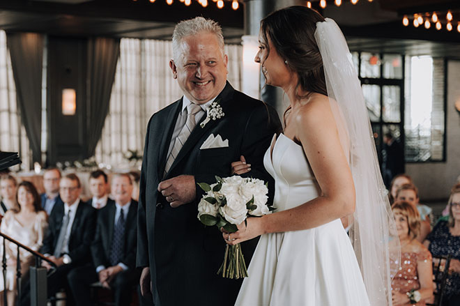 The father of the bride walks his daughter down the aisle at The Astorian.