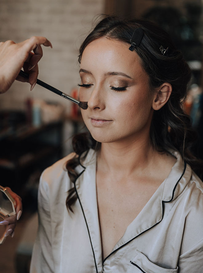 The bride gets her makeup done in the bridal suite at The Astorian.