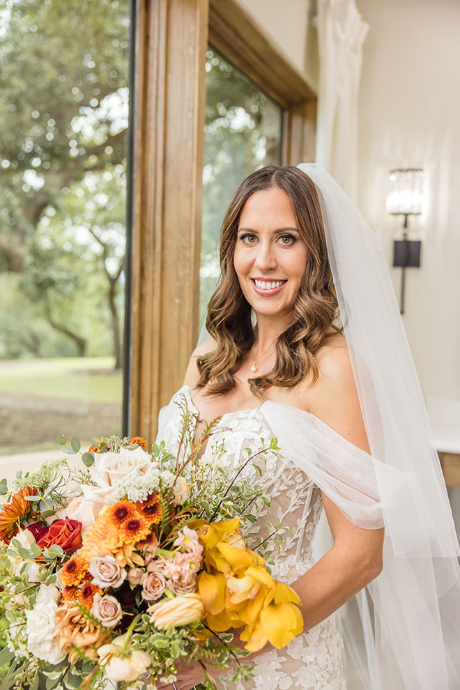 The bride holds her autumn-inspired wedding bouquet.