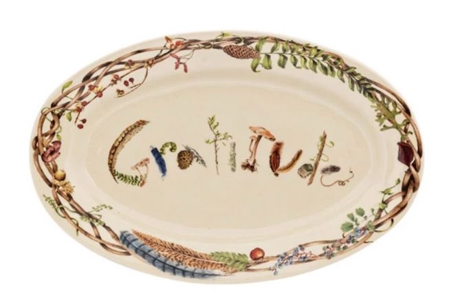 A platter that says Gratitude in different fall foliage that also lines the rim of the plate. 