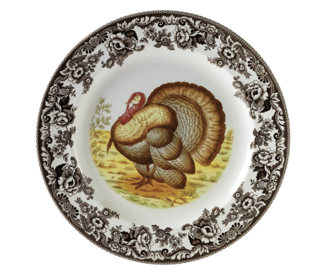 Brown flowers on the rim of the plate with a turkey in the middle. 