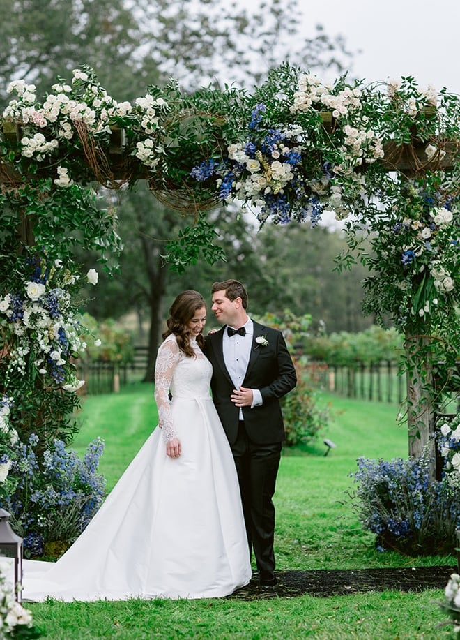 The bride and groom wed with an outdoor tented wedding at the bride's childhood home. 