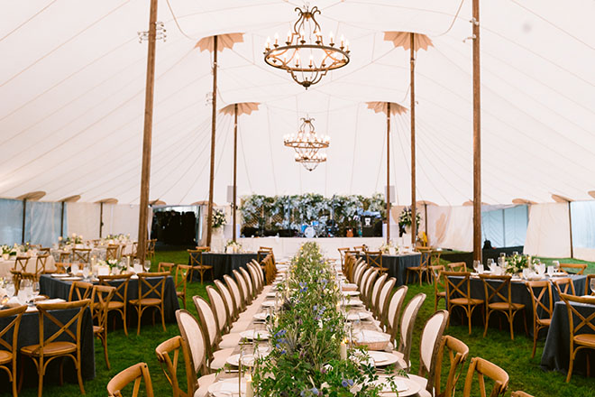 The bride and groom celebrate with an outdoor tented wedding at the bride's childhood home in Houston. 