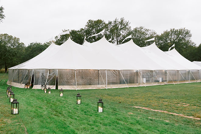 The bride and groom's wedding reception takes place in a tent at the bride's childhood home. 