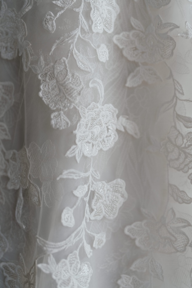 Floral embroidery on a white gown. 