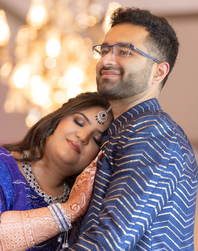 The bride resting her head on the groom's chest.