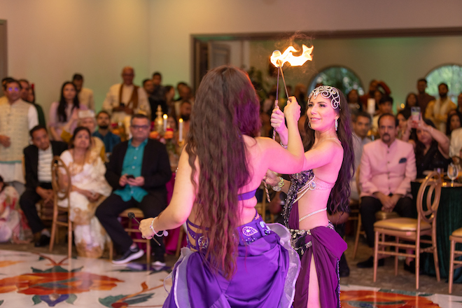 Two dancers performing with fire on the dance floor after the Sangeet. 