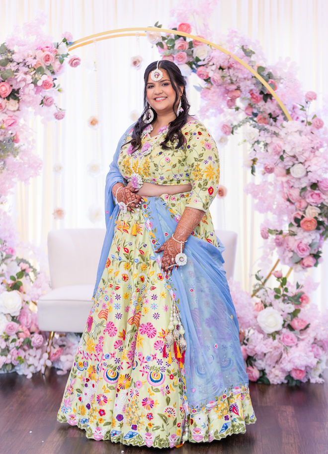 The bride in bright and traditional Indian attire. 