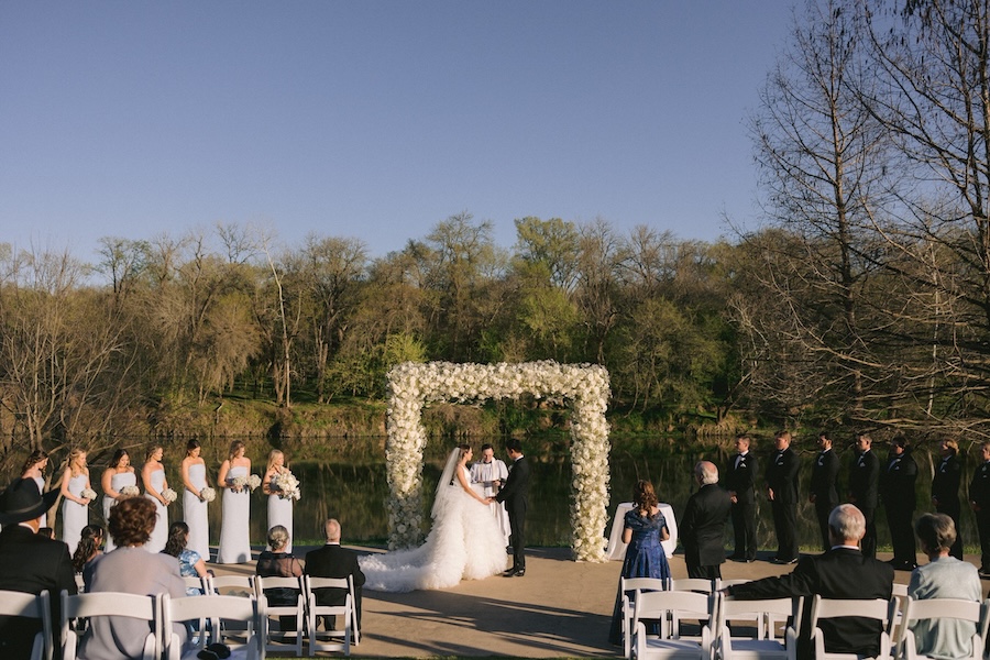 The bride and groom exchange vows at a Texas Hill Country wedding venue by the Colorado river. 