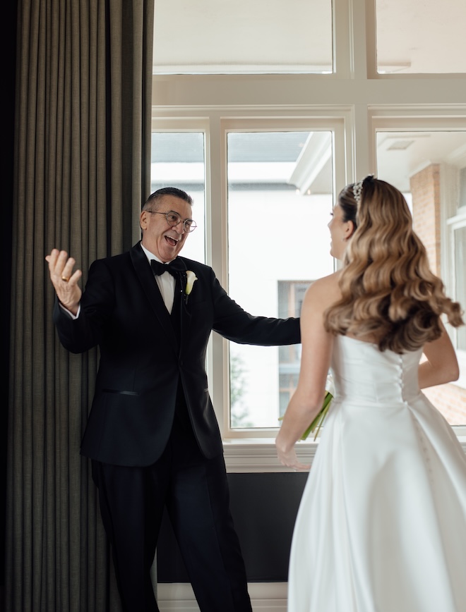 The father of the bride reacts with excitement during their first look. 