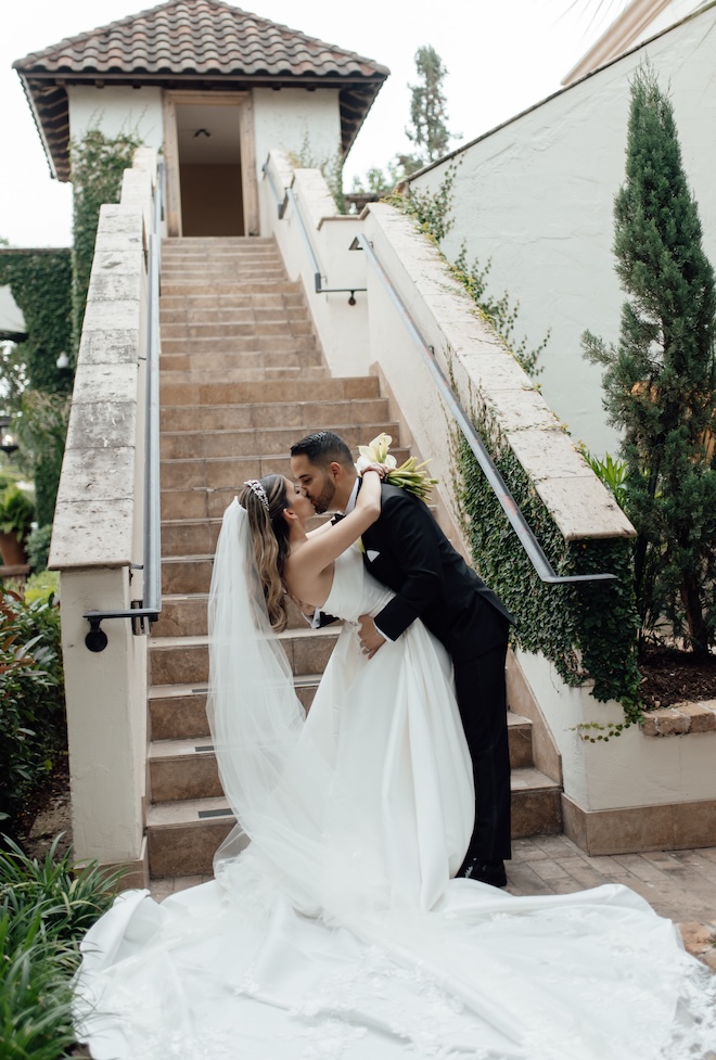 The bride and groom share a kiss outside the Houston wedding venue, The Bell Tower on 34th.