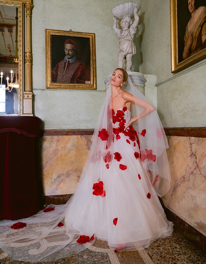 Monique Lhuillier designed a sheer wedding gown detailed in red florals. 