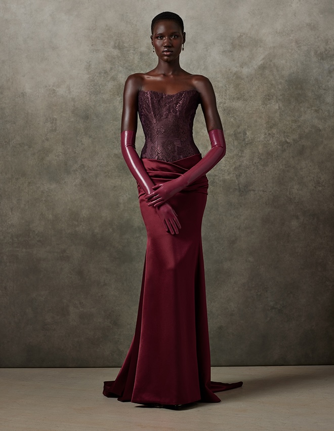 The model wears a dark-colored wedding dress by Ines Di Santo.