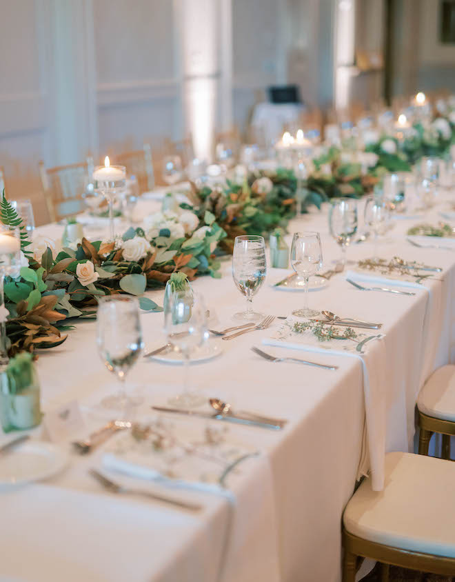 Sage green and gold accents adorn the reception tables. 